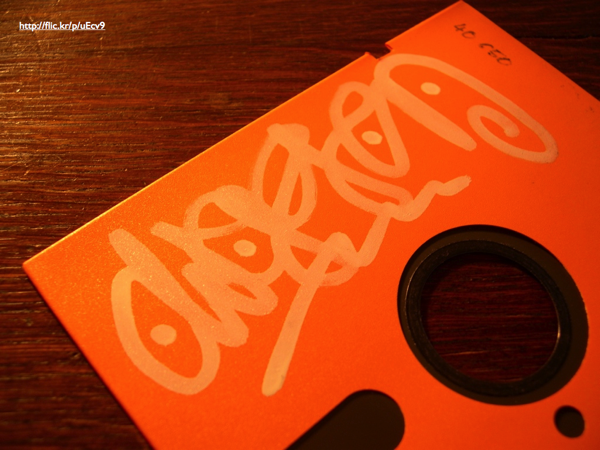 An orange 5.25-inch floppy disk