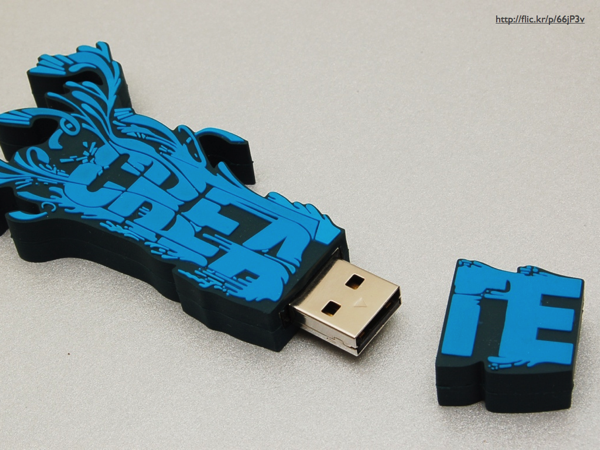 A flash drive in a rubber housing that spells 'Create'