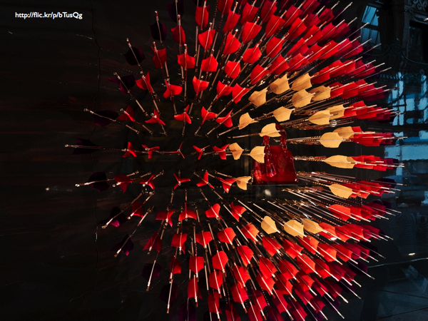 A bull's eye made of darts