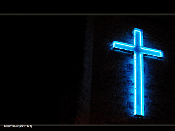 A neon blue cross