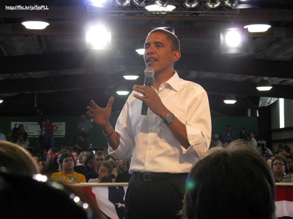 Barack Obama speaking in a town hall setting