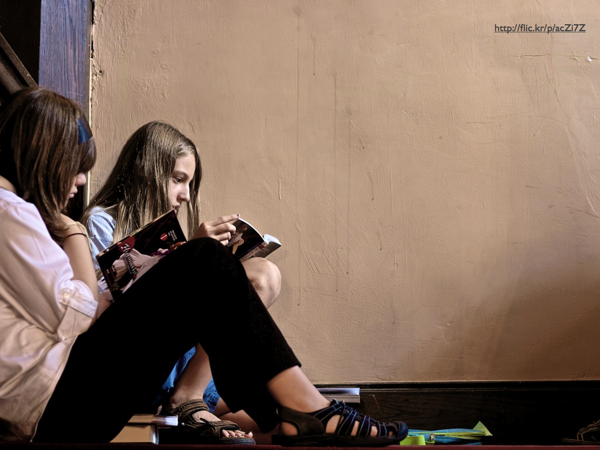 Two girls reading books