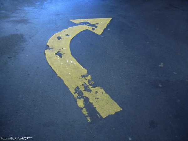 A peeling, right-turn arrow on a road