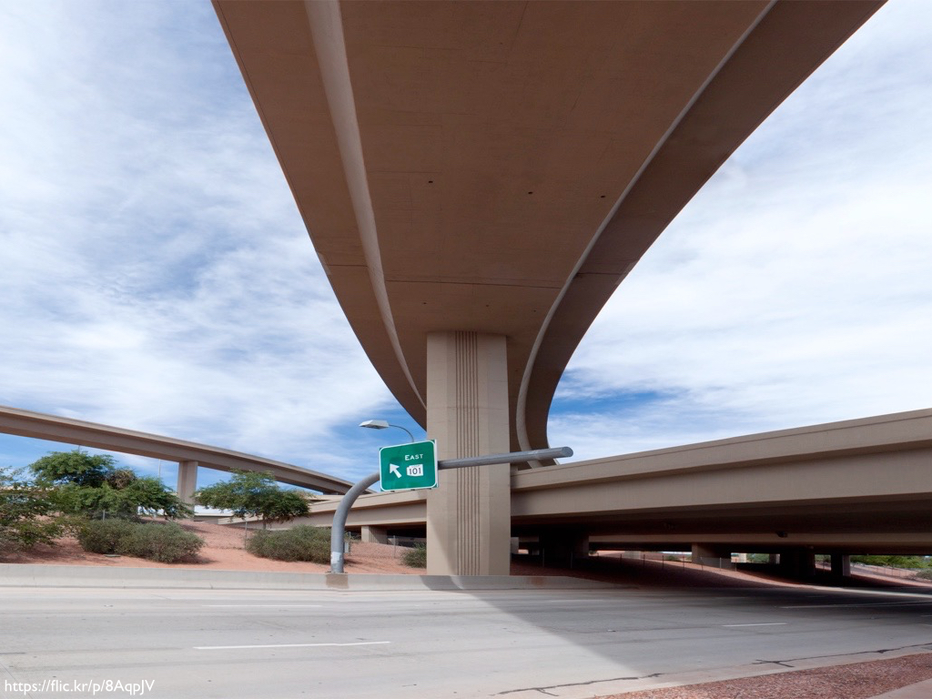 A freeway interchange shot from below so you can see multiple roadways.