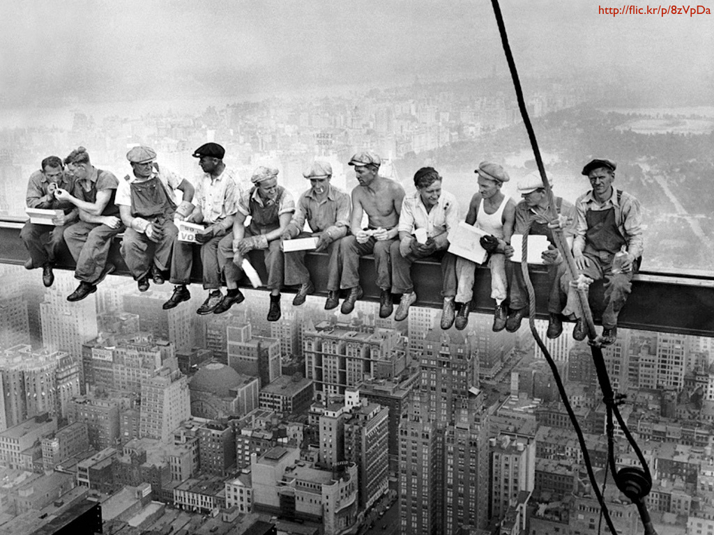 A group of men sitting on a skyscraper girder.