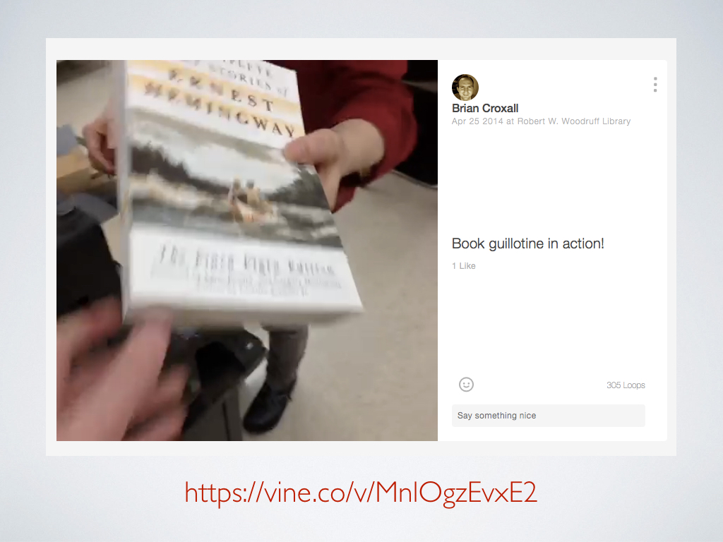 A screenshot of a Vine of Hemingway books being put through a book guillotine to have their bindings removed.